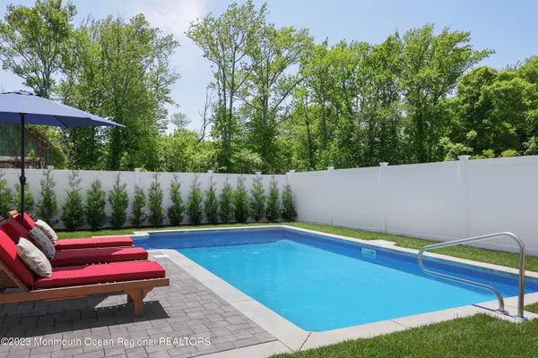 a backyard of a house with table and chairs