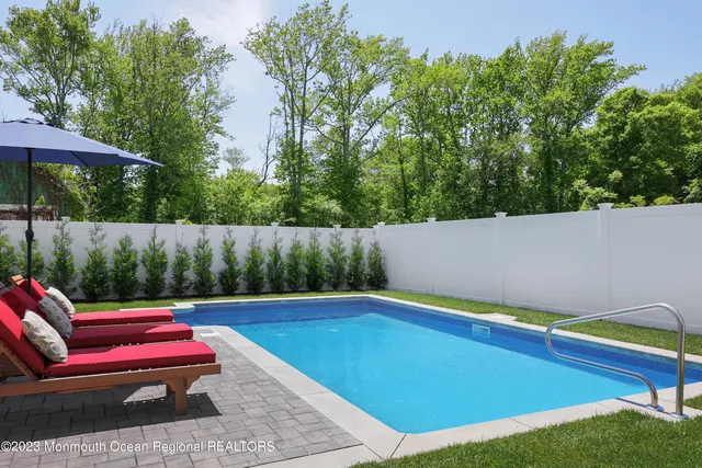a backyard of a house with table and chairs