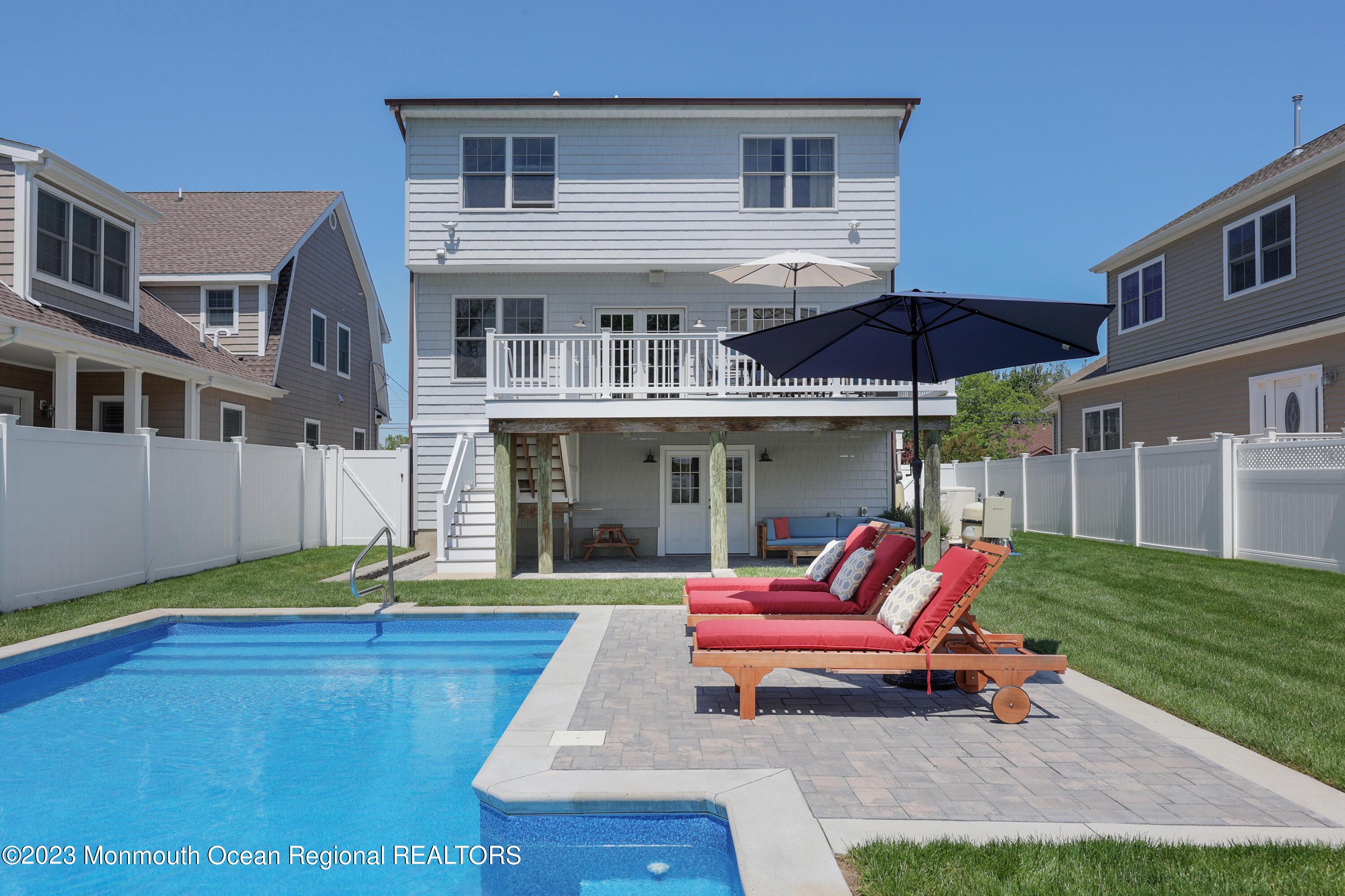 155 Osborn Avenue Bay Head, NJ 08742 - Photo 35 of 55 a yellow and red umbrella sitting in front of a house
