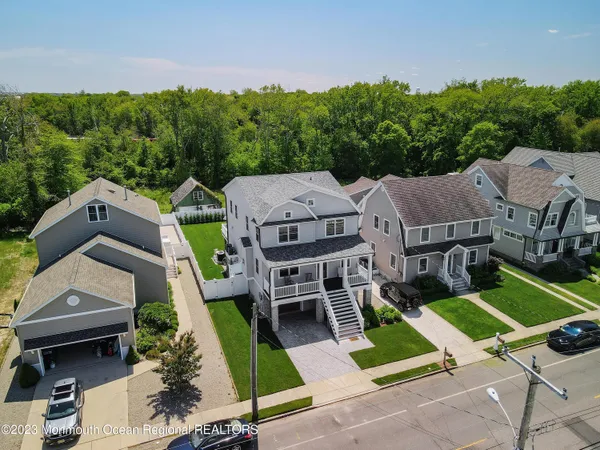 an aerial view of multiple houses with a yard