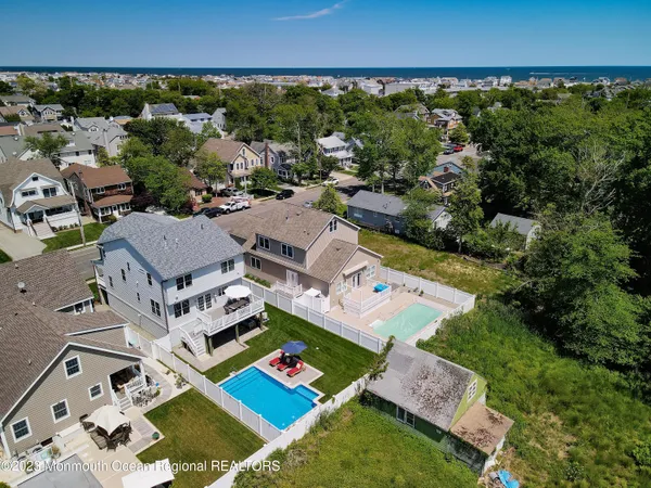 an aerial view of multiple houses with a big yard