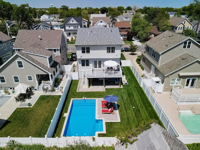 an aerial view of residential houses with outdoor space and parking