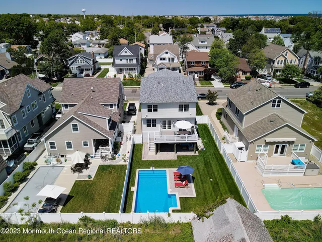 an aerial view of multiple houses with yard
