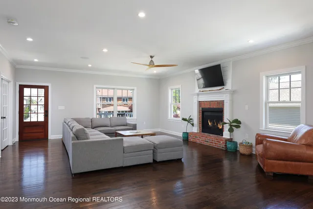a living room with furniture a fireplace and a flat screen tv