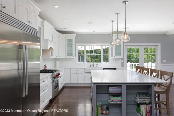 a kitchen with granite countertop a sink appliances and window