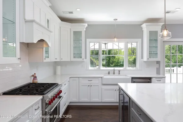 a kitchen with a sink a stove and cabinets
