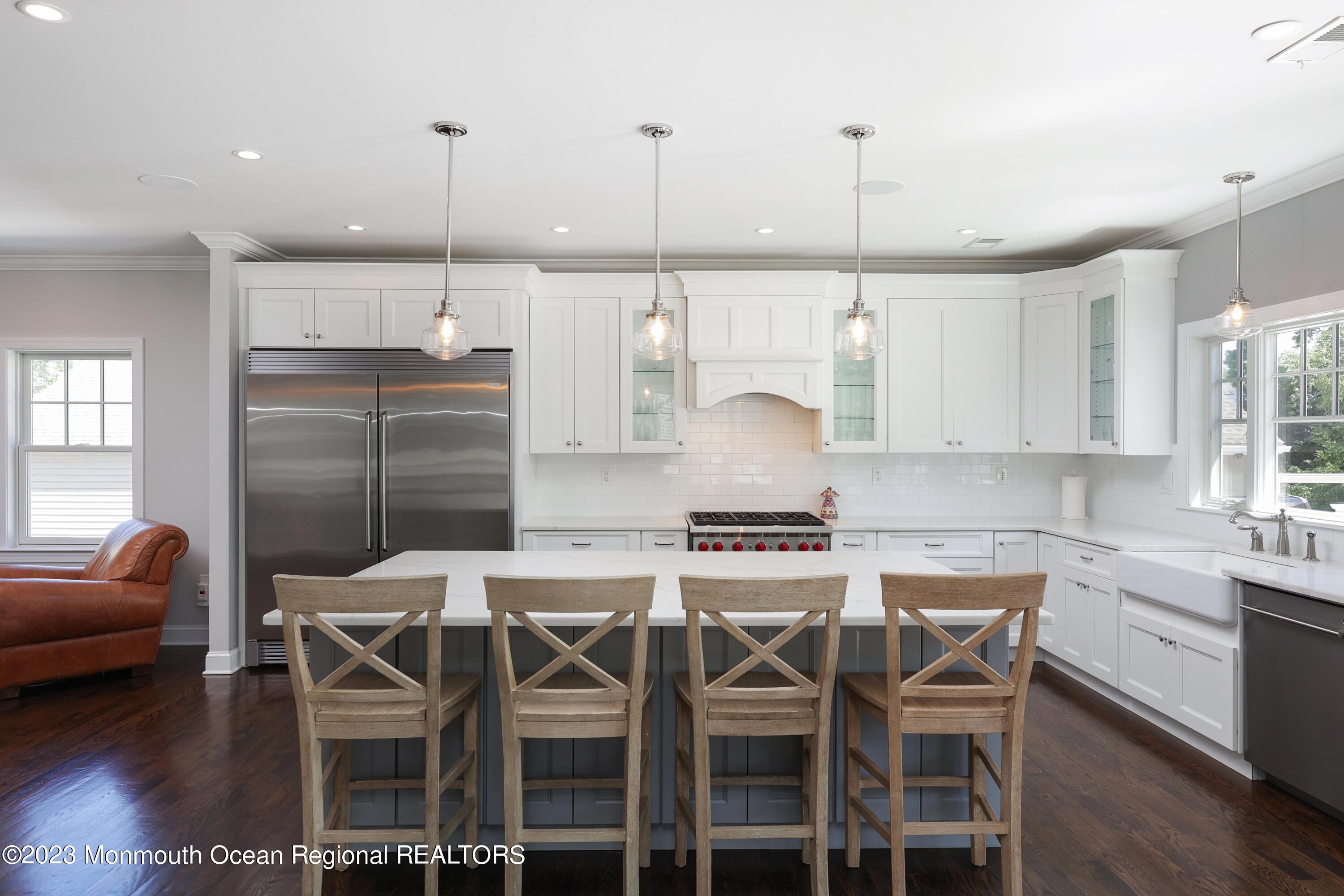 155 Osborn Avenue Bay Head, NJ 08742 - Photo 10 of 55 a kitchen with stainless steel appliances kitchen island granite countertop a dining table chairs and white cabinets