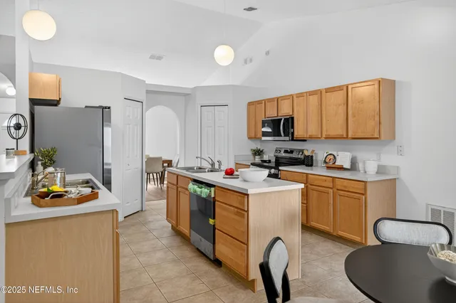 a kitchen with a sink appliances and cabinets