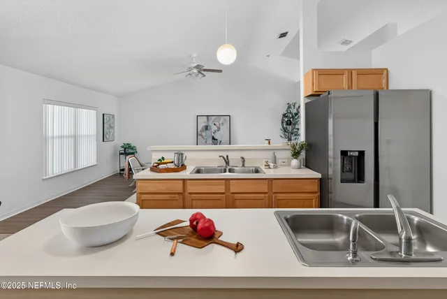 a kitchen with a refrigerator and a sink