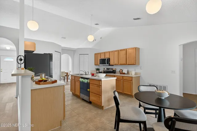 a kitchen with a sink stove and white cabinets
