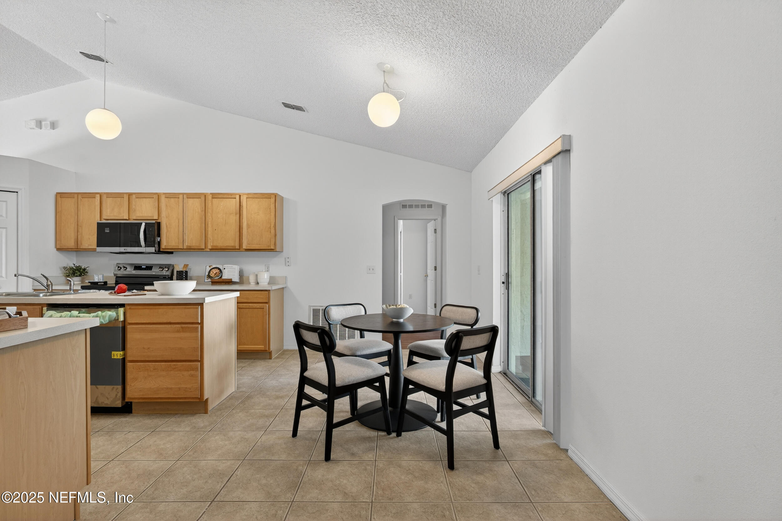 12405 Hickory Forest Road Jacksonville, FL 32226 - Photo 22 of 48 a view of a dining room with furniture and wooden floor
