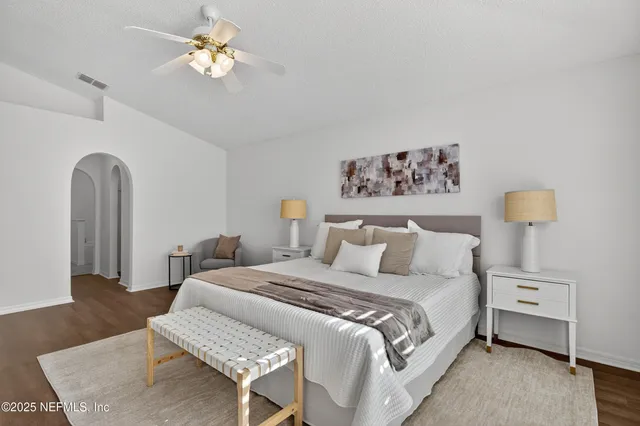 a bedroom with a bed and a chandelier