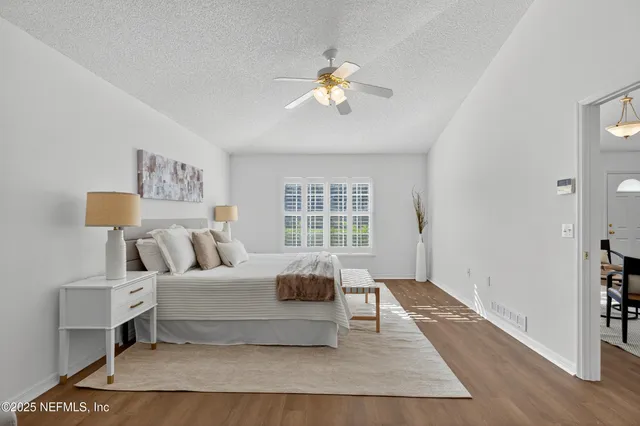 a living room with a bed furniture and a window
