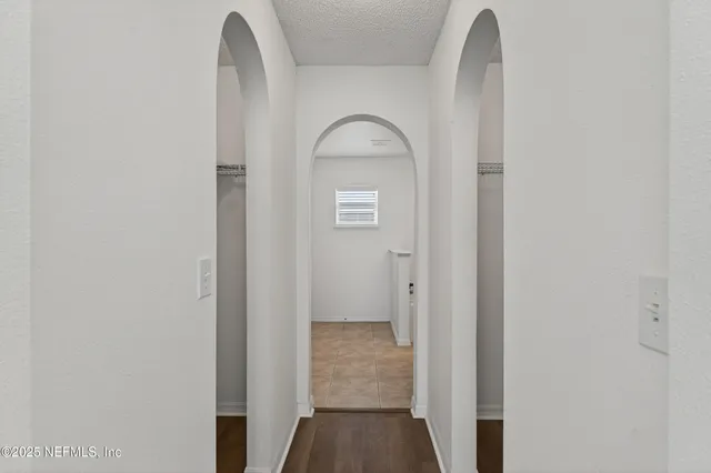 a view of a hallway with wooden floor