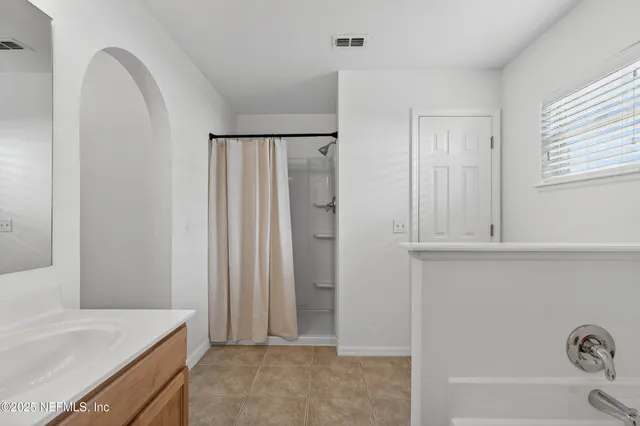 a bathroom with a bathtub and a sink