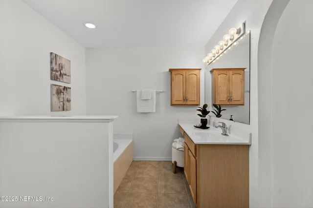 a bathroom with a sink vanity and mirror