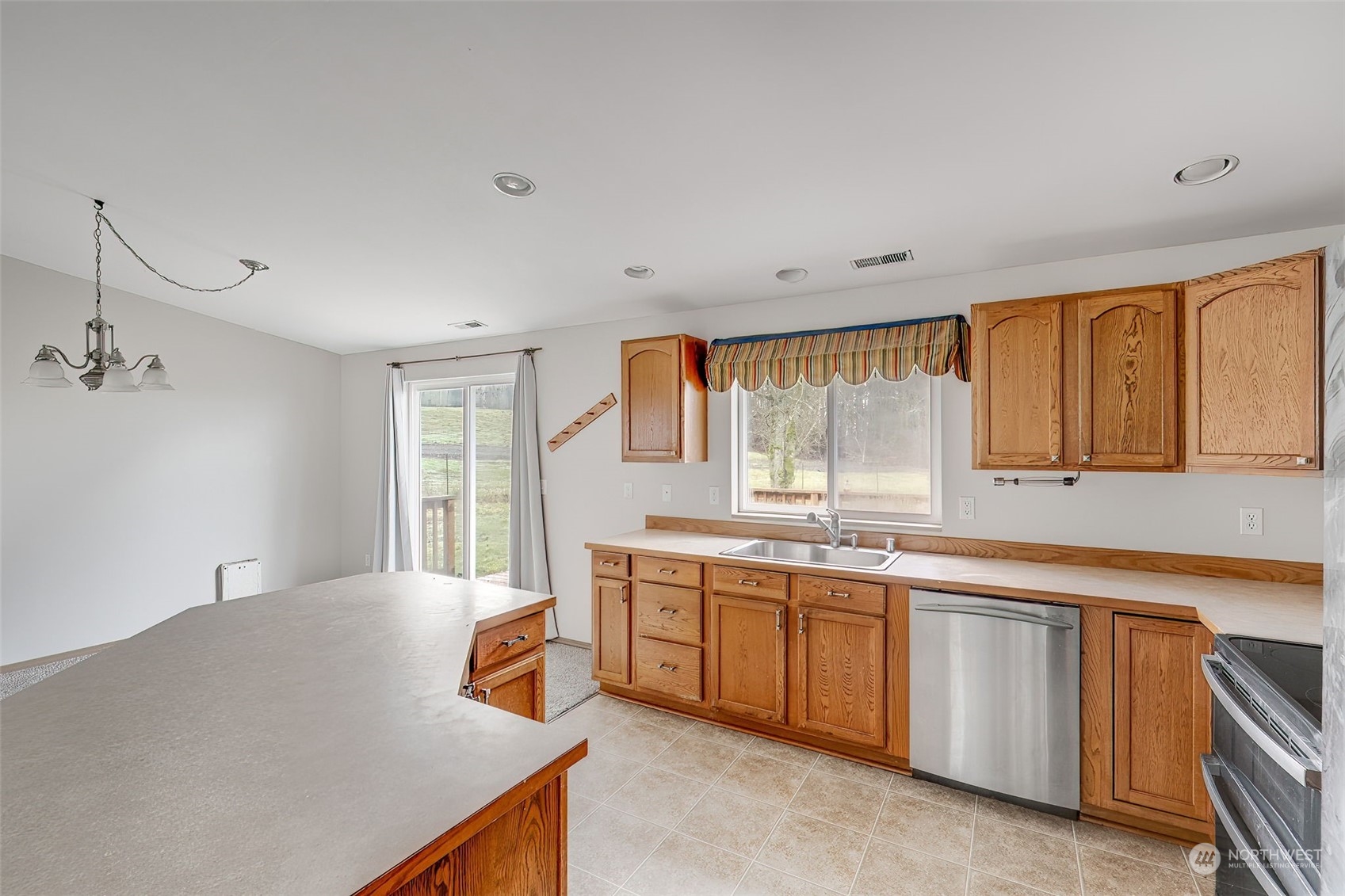137 Ridgecrest Drive Longview, WA 98632 - Photo 12 of 40 a kitchen with a sink stove and cabinets