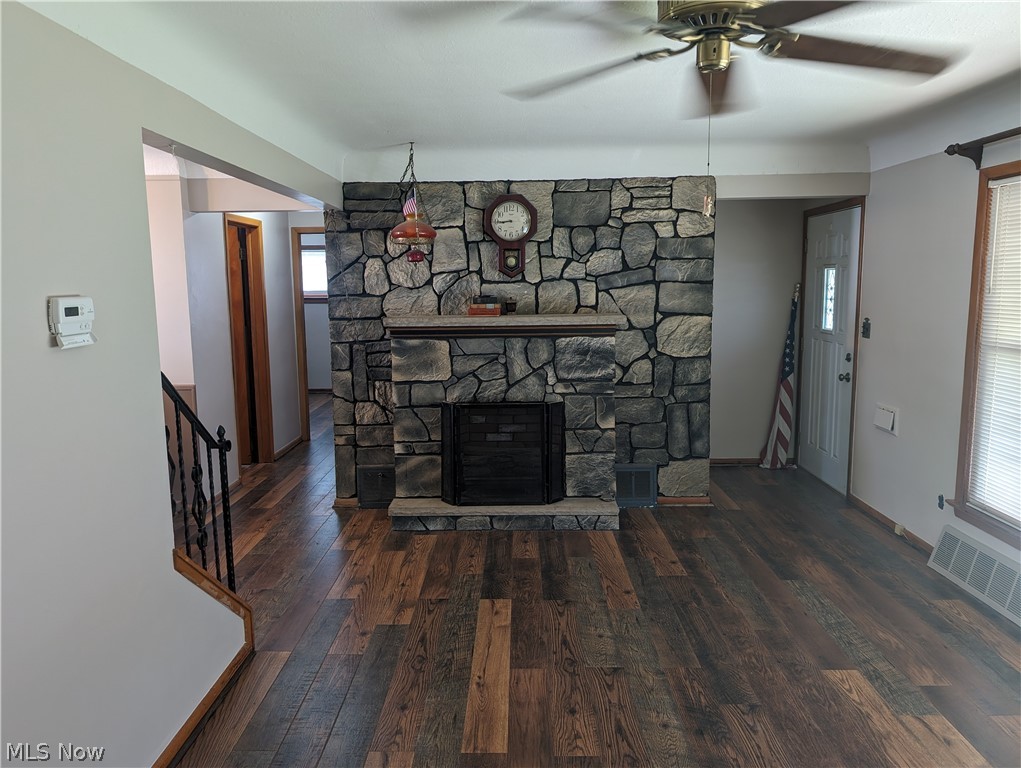 30213 Barjode Road Willowick, OH 44095 - Photo 8 of 20 Unfurnished living room featuring a stone fireplace, ceiling fan, and hardwood / wood-style floors