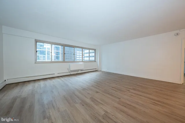 a view of an empty room and wooden floor