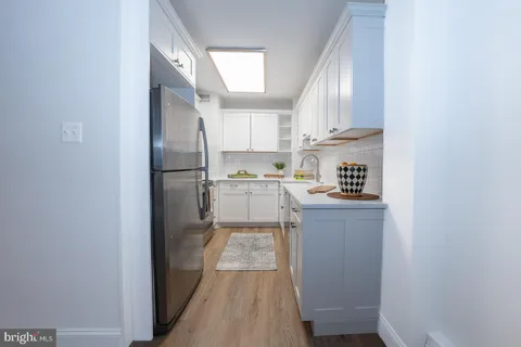 a view of a kitchen and wooden floor