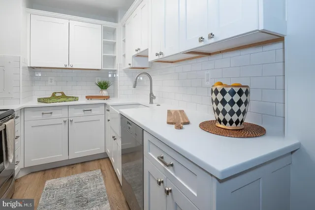 a kitchen with cabinets stainless steel appliances and a sink