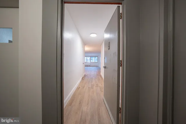 a view of hallway with wooden floor