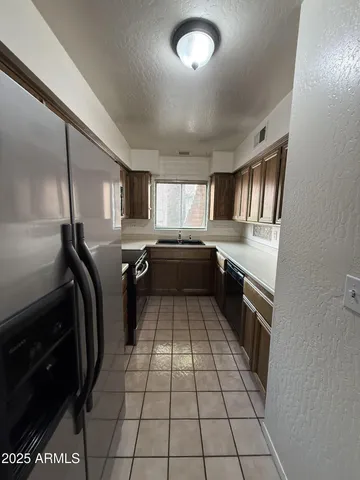 a kitchen with granite countertop stainless steel appliances and counter space