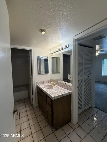 a bathroom with a sink vanity and mirror