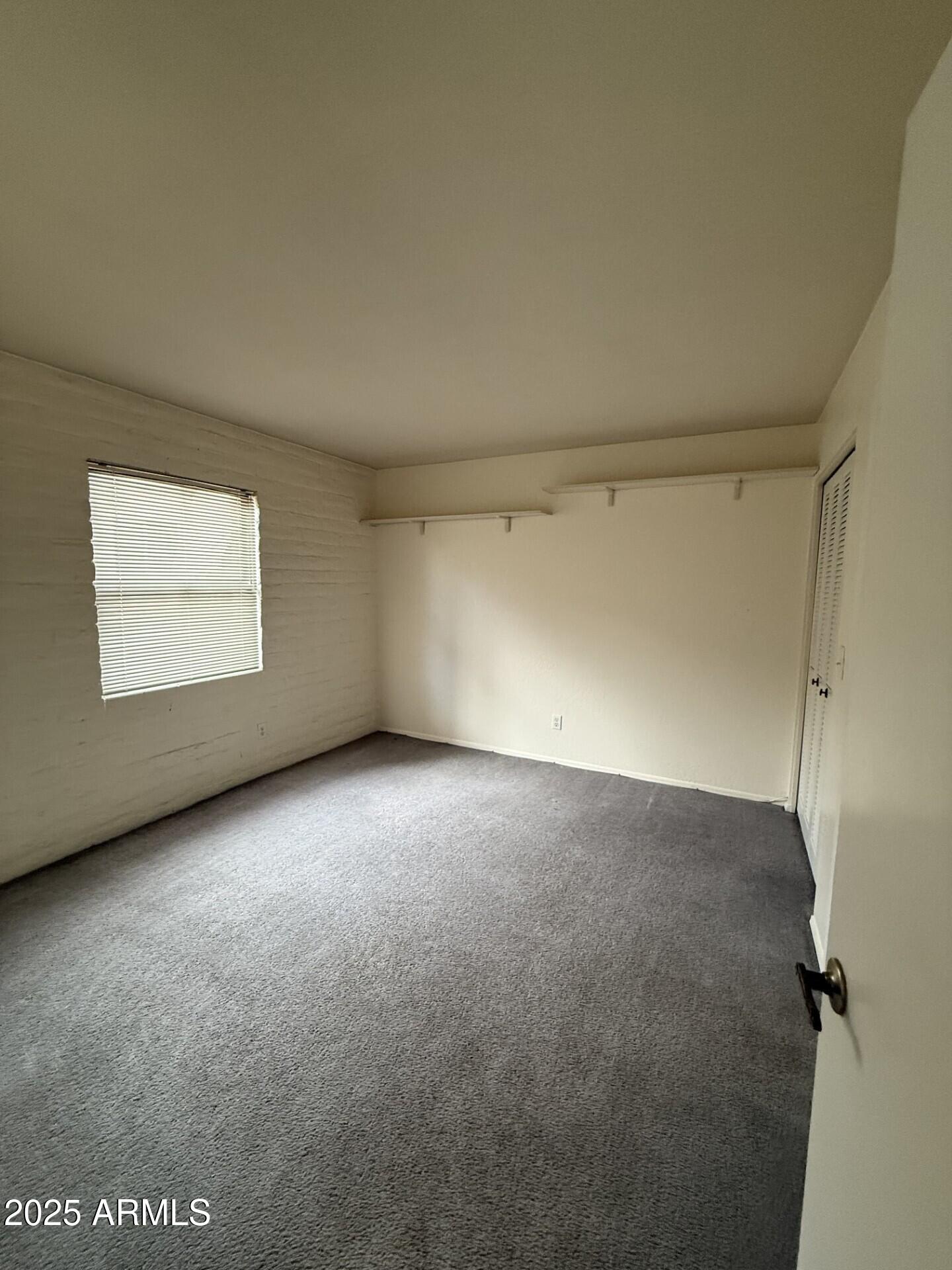 4414 East Hubbell Street, Unit 69 Phoenix, AZ 85008 - Photo 7 of 10 an empty room with a workbench