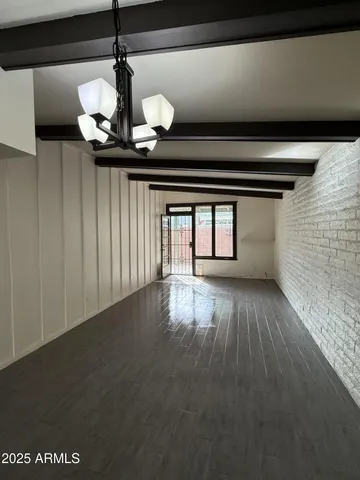 a view of wooden floor and window in a room