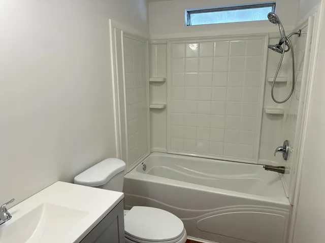 a bathroom with a toilet and a shower