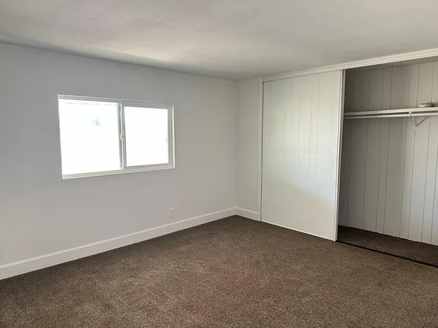 an empty room with a empty space and windows