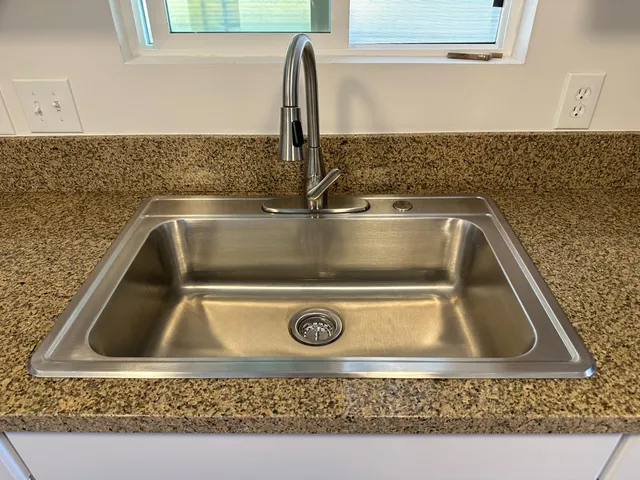 a kitchen with a sink stove and refrigerator