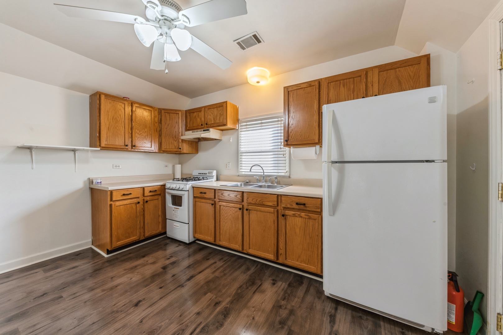 425 East 9th Street, Unit 2 Lockport, IL 60441 - Photo 3 of 7 a kitchen with a refrigerator a sink and dishwasher with wooden floor