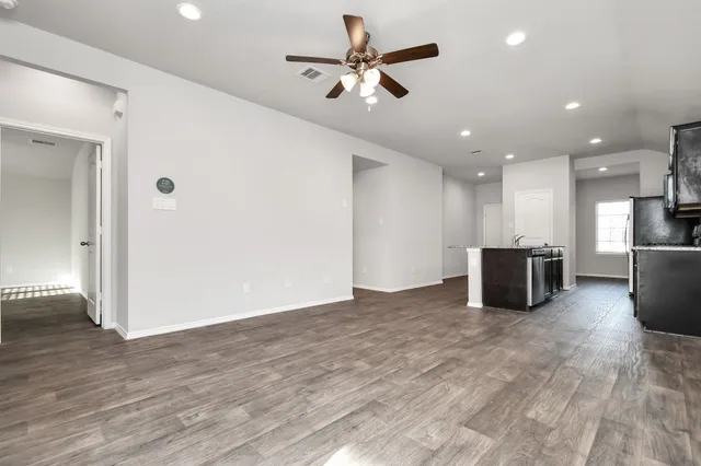 a view of kitchen with stove and refrigerator