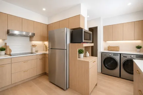 a utility room with refrigerator a washer and dryer