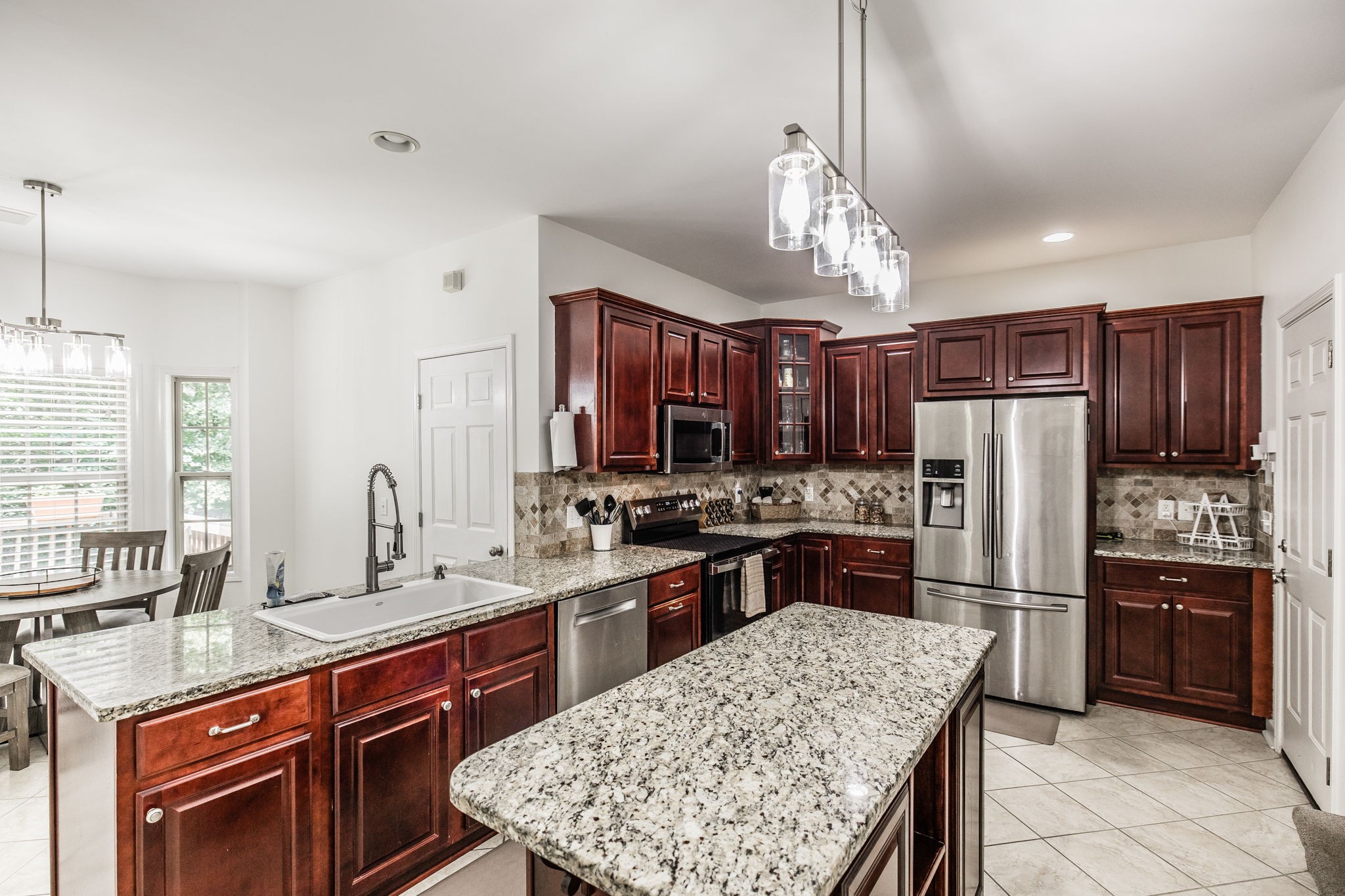 2860 Morgan Road Joelton, TN 37080 - Photo 4 of 45 a kitchen with stainless steel appliances granite countertop granite counter tops refrigerator a stove a sink and a center island
