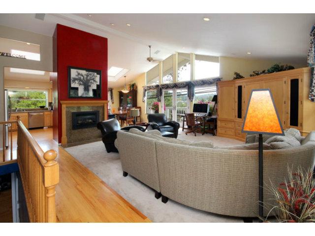 293 Arrowhead Way Scotts Valley, CA 95066 - Photo 3 of 25 a living room with furniture a flat screen tv and a fireplace