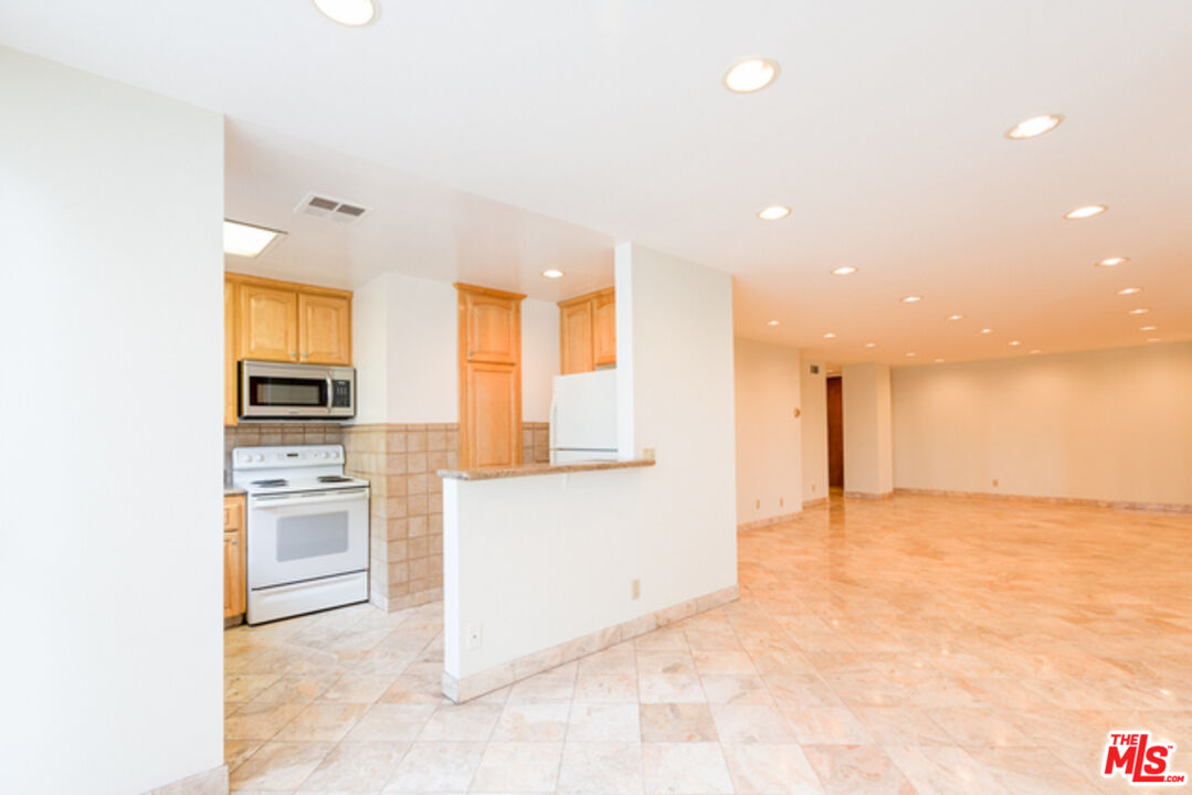 10747 Wilshire Boulevard, Unit 905 Los Angeles, CA 90024 - Photo 6 of 7 a view of a kitchen with a sink and a refrigerator