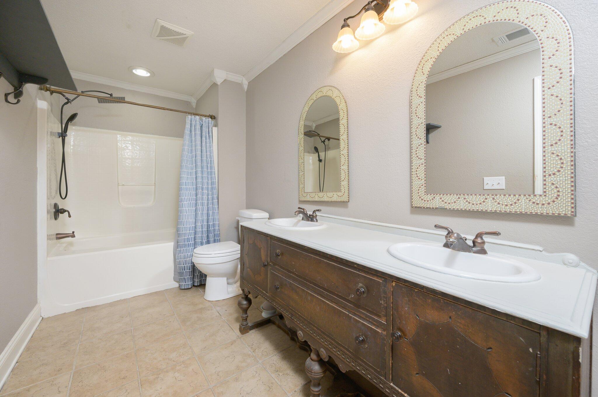111 Sikes Drive Crestview, FL 32539 - Photo 11 of 46 a bathroom with a double vanity sink toilet mirror and bathtub