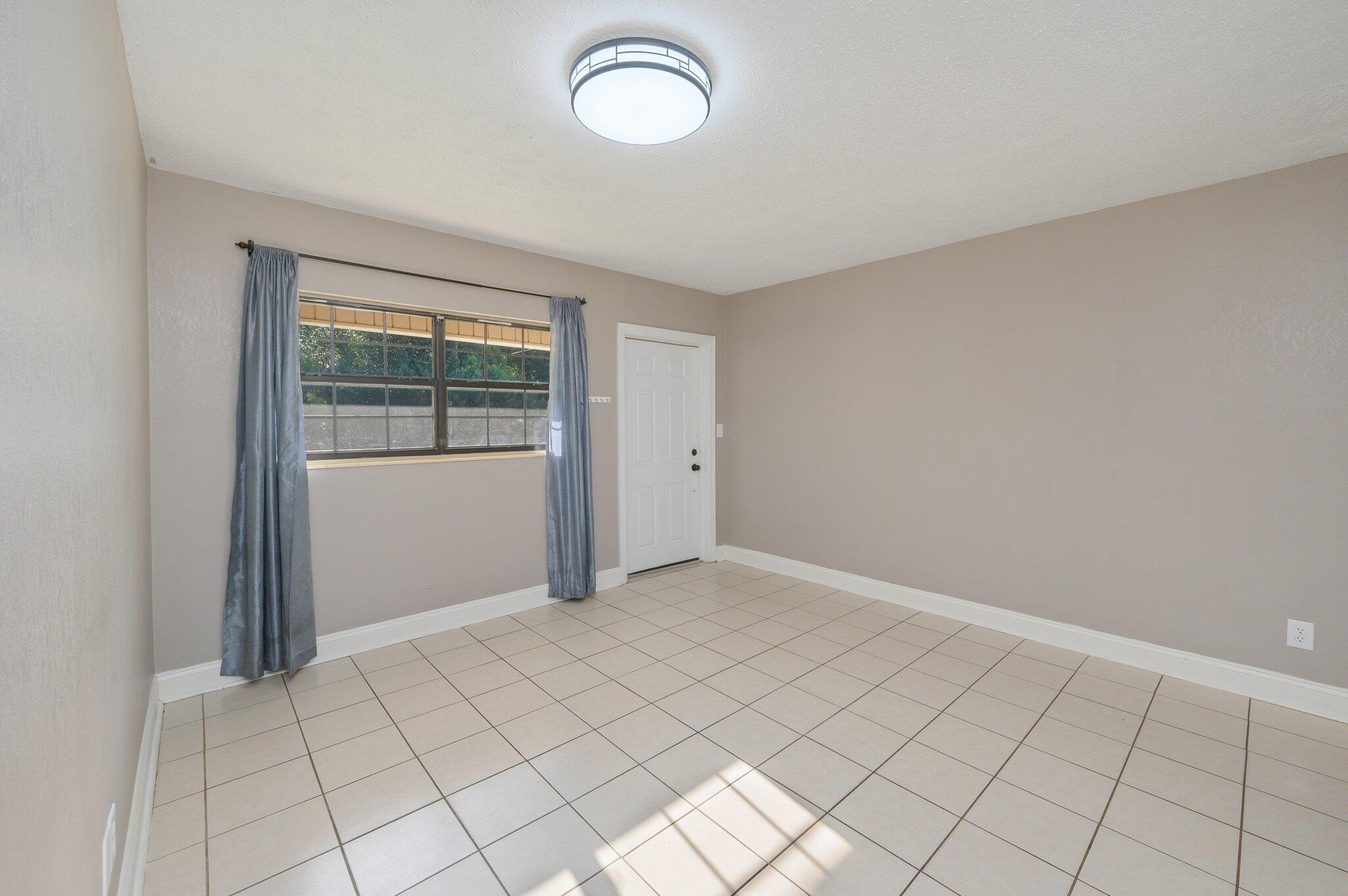 111 Sikes Drive Crestview, FL 32539 - Photo 17 of 46 an empty room with windows
