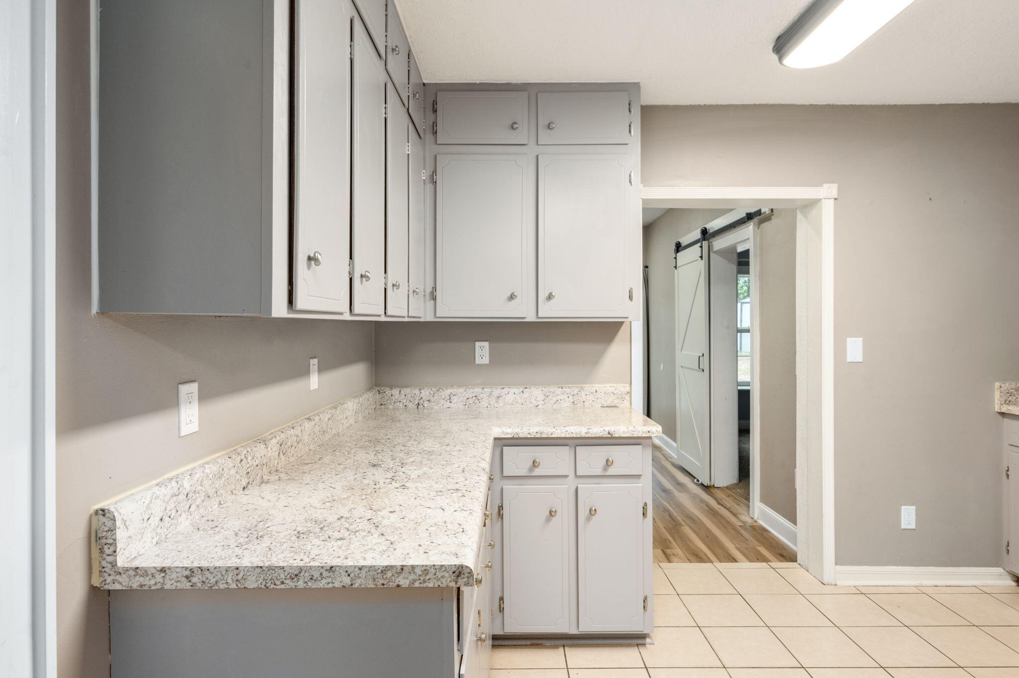 111 Sikes Drive Crestview, FL 32539 - Photo 18 of 46 a kitchen with granite countertop white cabinets and refrigerator