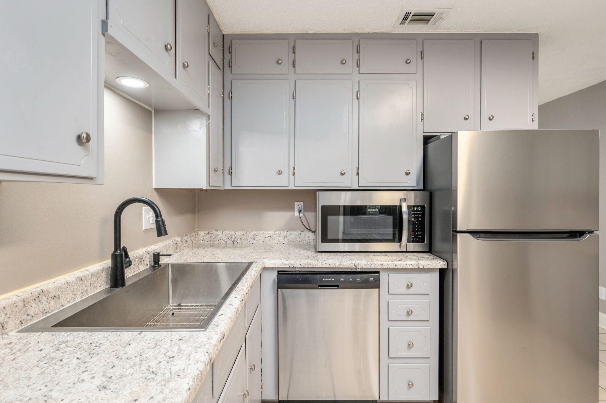 111 Sikes Drive Crestview, FL 32539 - Photo 19 of 46 a kitchen with refrigerator a stove a sink and a counter space