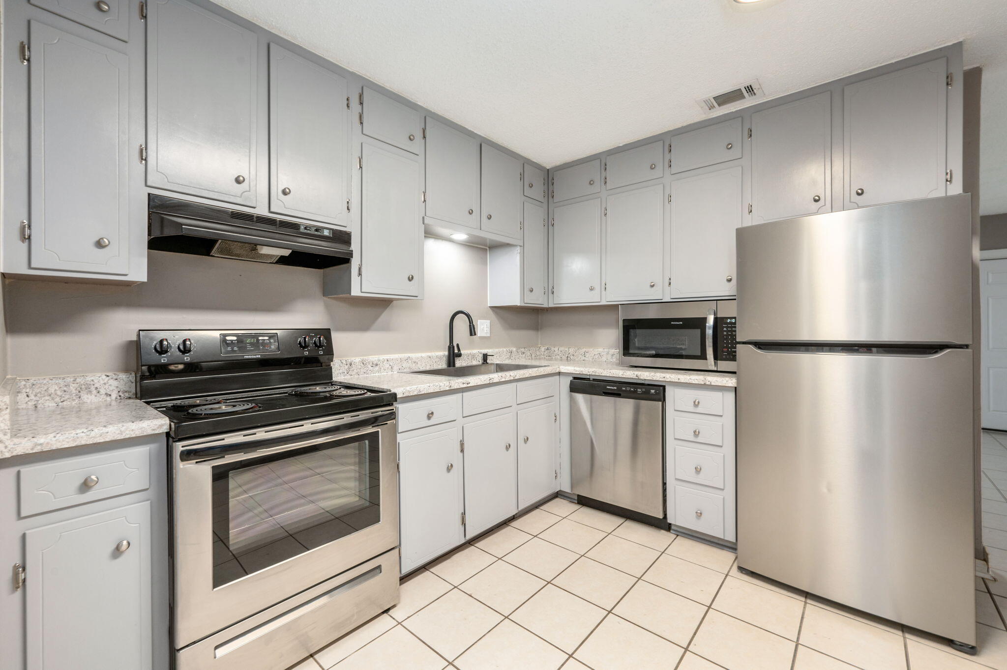 111 Sikes Drive Crestview, FL 32539 - Photo 20 of 46 a kitchen with white cabinets and stainless steel appliances
