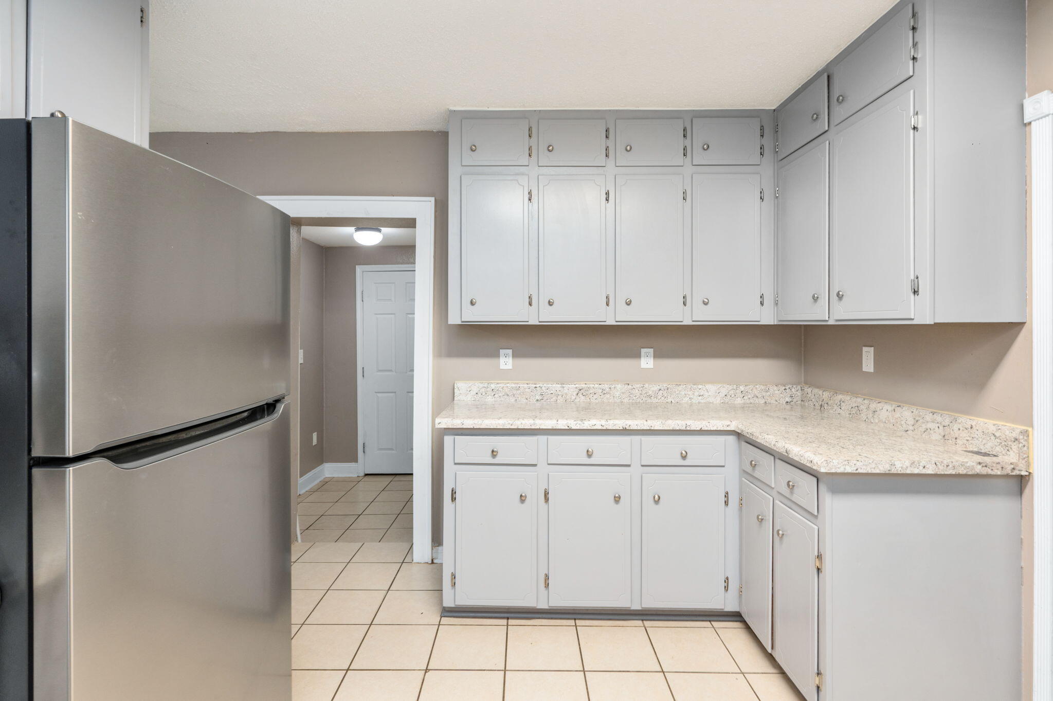 111 Sikes Drive Crestview, FL 32539 - Photo 21 of 46 a kitchen with white cabinets and refrigerator