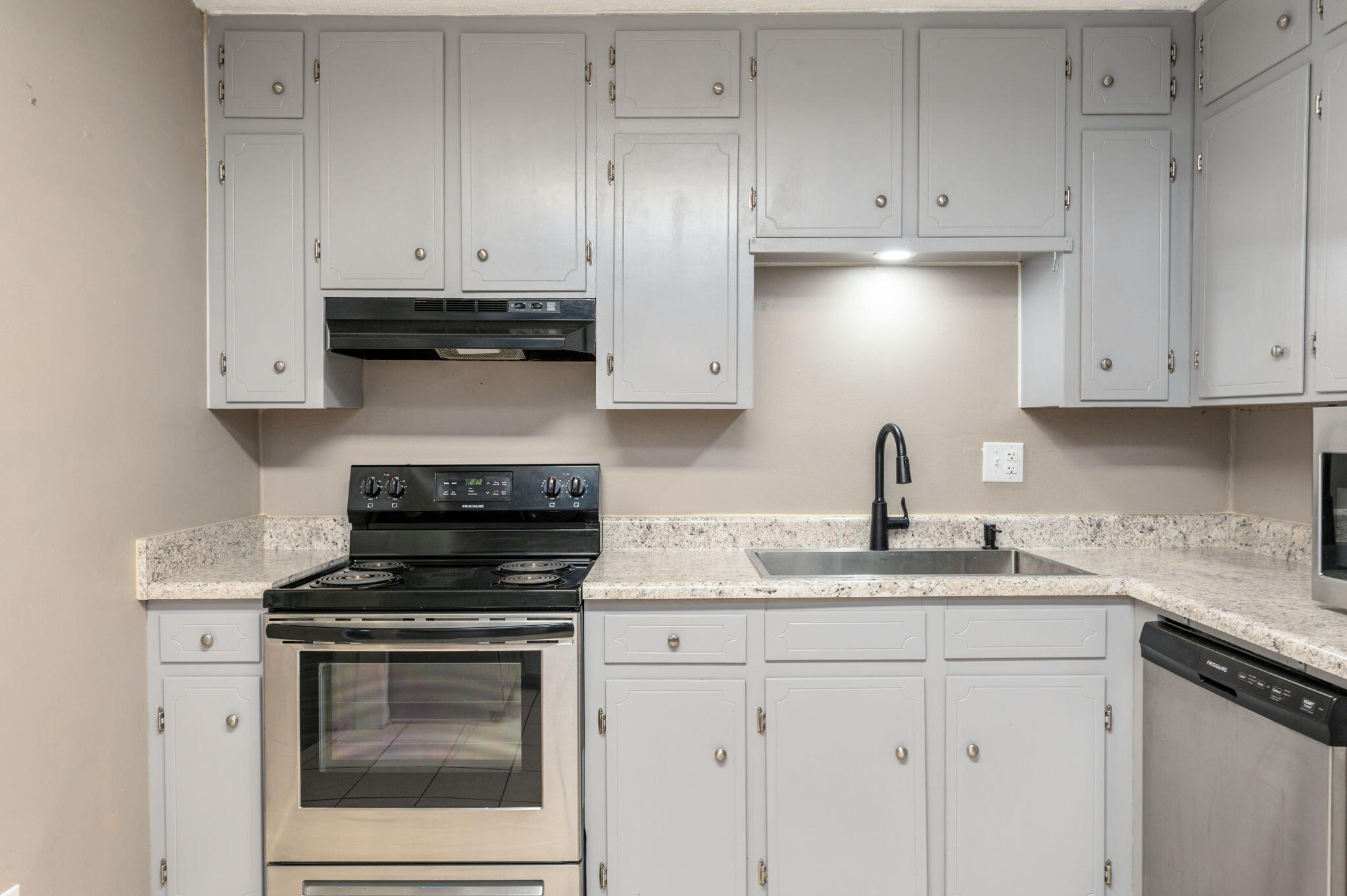 111 Sikes Drive Crestview, FL 32539 - Photo 23 of 46 a kitchen with granite countertop white cabinets and stainless steel appliances