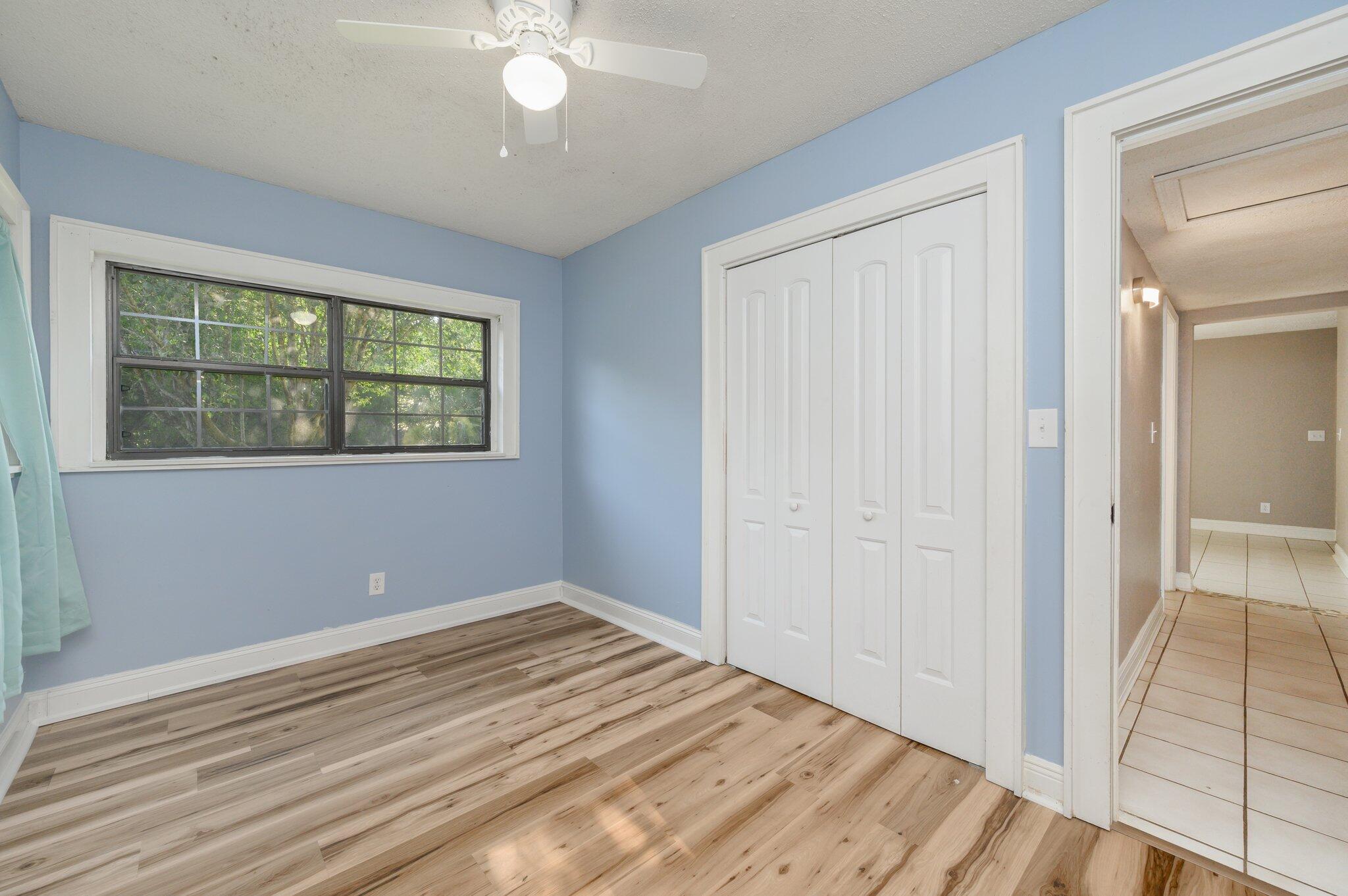 111 Sikes Drive Crestview, FL 32539 - Photo 29 of 46 a view of empty room with wooden floor and fan