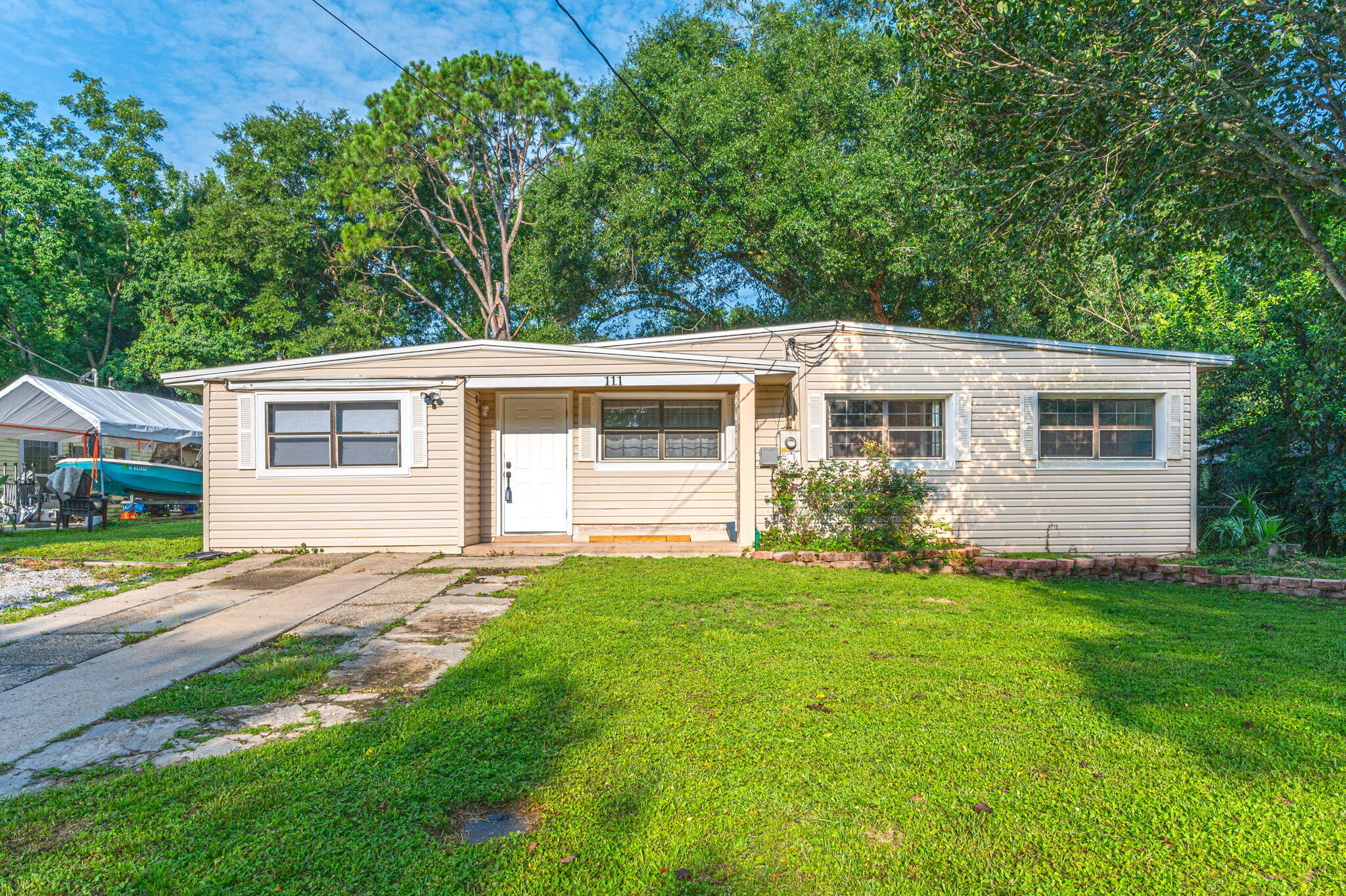 111 Sikes Drive Crestview, FL 32539 - Photo 36 of 46 a view of a backyard with plants and large trees