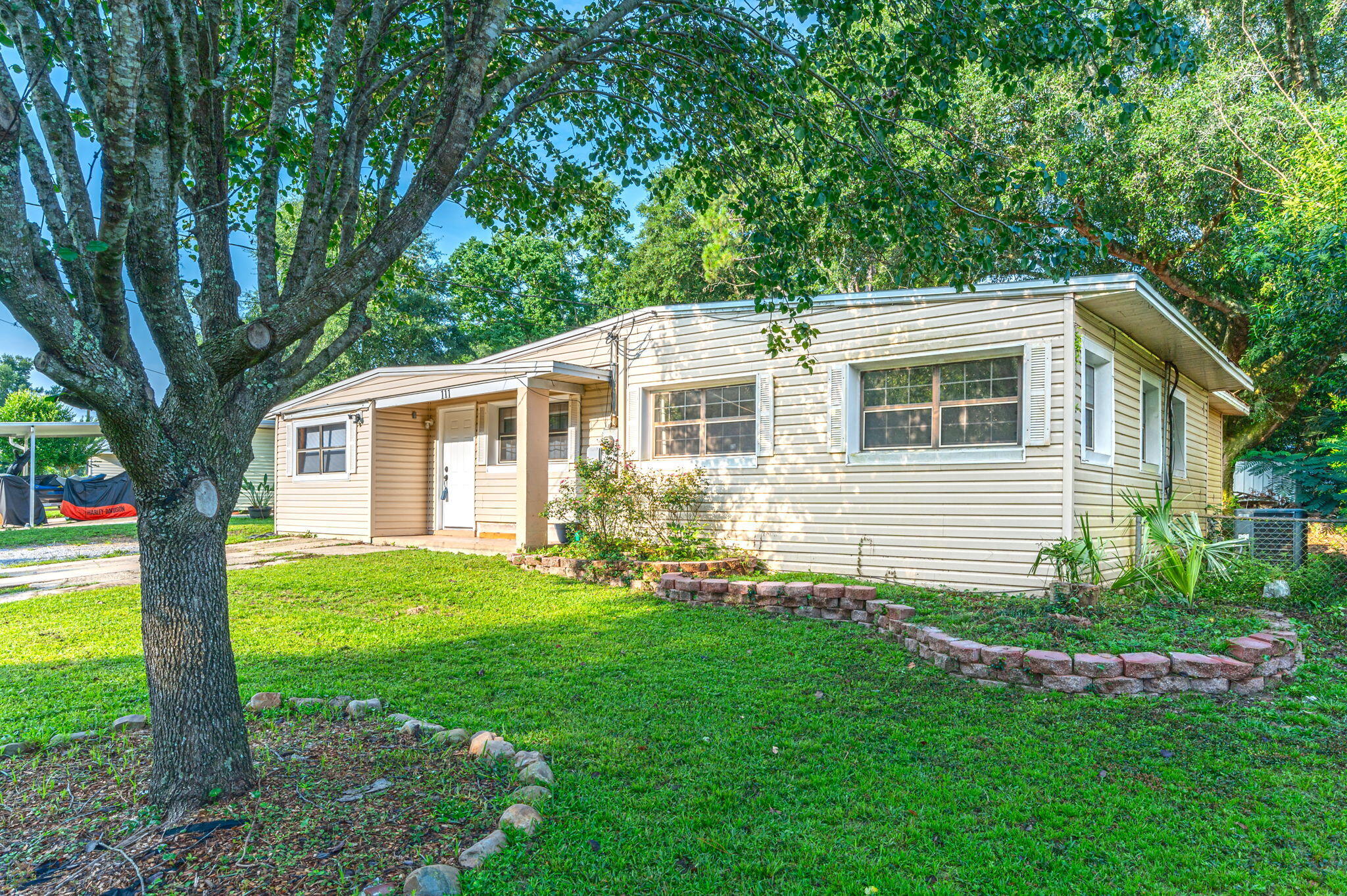 111 Sikes Drive Crestview, FL 32539 - Photo 38 of 46 a front view of house with a garden and patio