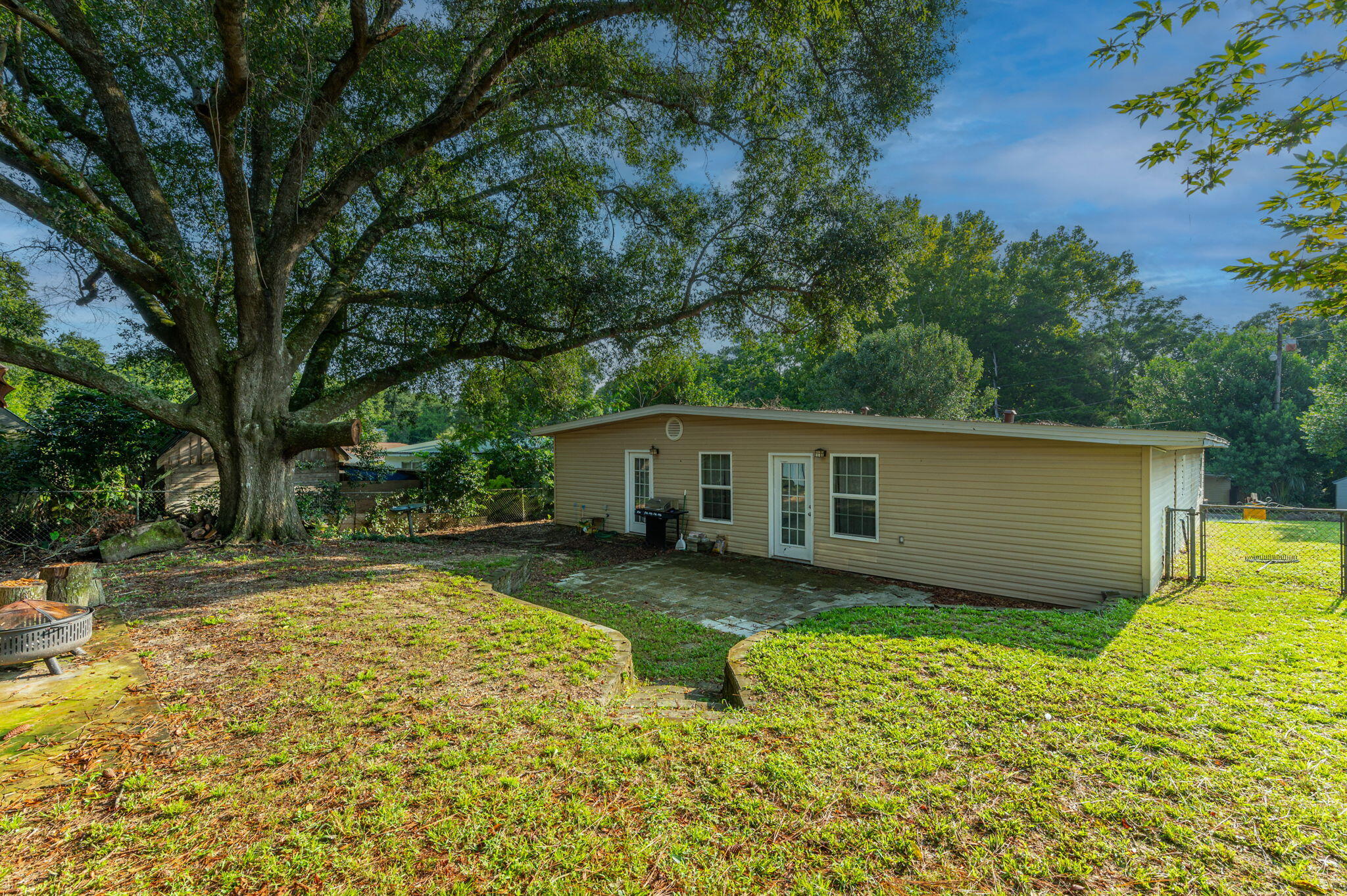 111 Sikes Drive Crestview, FL 32539 - Photo 39 of 46 a view of a house with pool and a garden